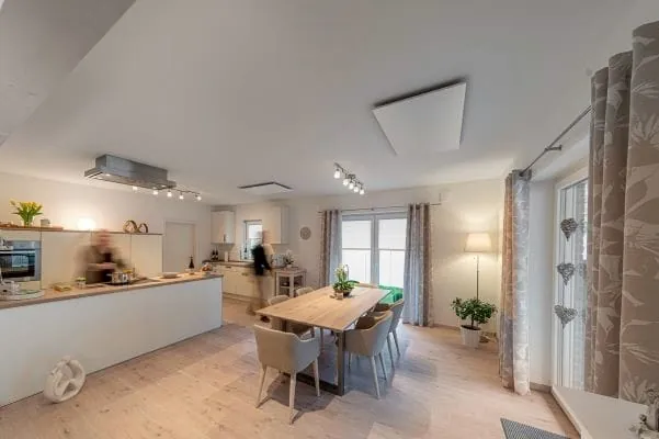 Wohnk&uuml;che mit Esstisch im Zentrum in Einfamilienhaus mit Infrarot-Heizelement an der Decke