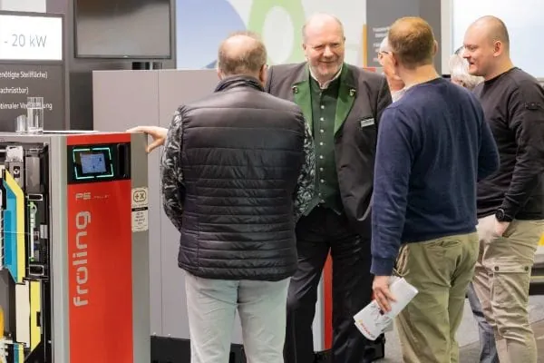 Aussteller Holzheizkessel im Gespräch mit Messebesuchern aus dem Handwerk