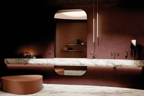 Die gemeinsame PVD-Oberfläche Bronze gebürstet verbindet die Armatur der Serie Vaia von Dornbracht mit dem Jung-Taster F 40 mit vier Bedienstellen und der passenden Steckdose LS 990 visuell und haptisch.