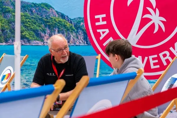 Dieter Meyer (l.) klärt über den Beruf des Kraftfahrzeugmechatronikers auf.
