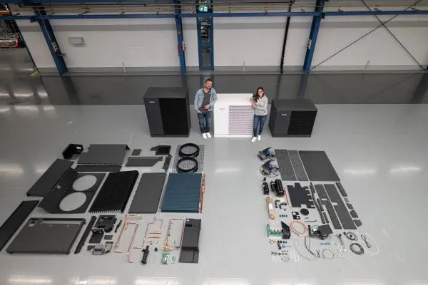 Bauteile einer Wärmepumpe zerlegt, mit den beiden Moderatoren von Stiebel Eltron